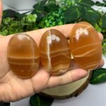 Beautiful Red Honey Calcite Palm Stone